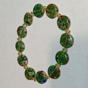 Green beach bracelet with multi colored flowers.(sku 113)